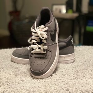 Gray, white, and black Nike Air Force One’s